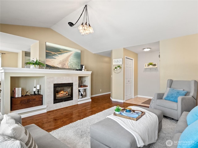 800 96th Ave NE Unit H202, Lake Stevens, WA 98258 - living area featuring wood finished floors, a tiled fireplace, vaulted ceiling, and a chandelier