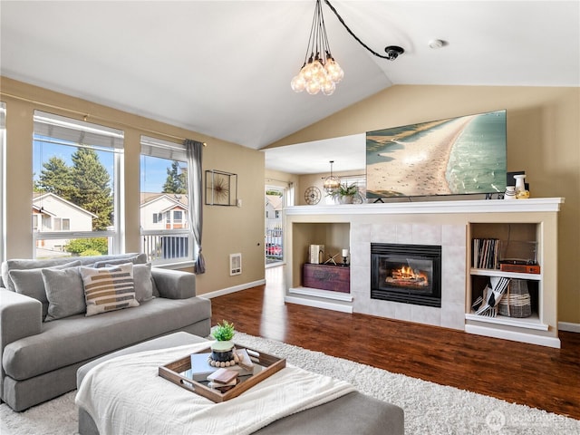 800 96th Ave NE Unit H202, Lake Stevens, WA 98258 - living room with wood finished floors, lofted ceiling, a tile fireplace, and a chandelier