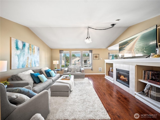 800 96th Ave NE Unit H202, Lake Stevens, WA 98258 - living room with lofted ceiling, dark wood finished floors, a tile fireplace, and a chandelier