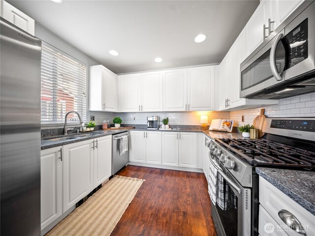 800 96th Ave NE Unit H202, Lake Stevens, WA 98258 - kitchen featuring stainless steel appliances, dark wood-type flooring, decorative backsplash, white cabinets, and recessed lighting