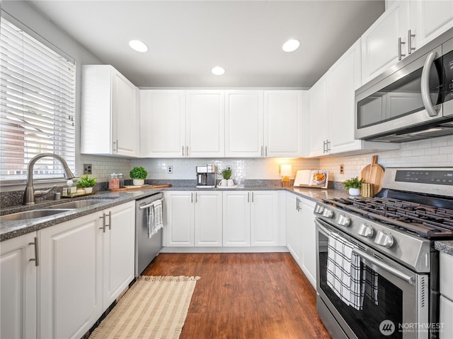 800 96th Ave NE Unit H202, Lake Stevens, WA 98258 - kitchen with stainless steel appliances, dark wood-style flooring, backsplash, white cabinets, and recessed lighting
