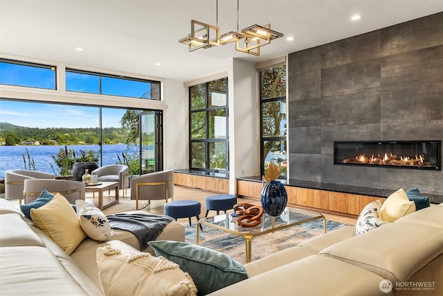 3840 E Mercer Way, Mercer Island, WA 98040 - living area with floor to ceiling windows, recessed lighting, a fireplace, wood finished floors, and a water view
