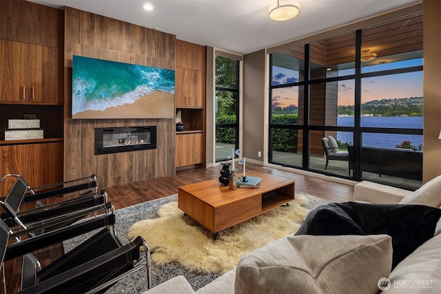 3840 E Mercer Way, Mercer Island, WA 98040 - living area with wood finished floors, a glass covered fireplace, a wall of windows, and recessed lighting