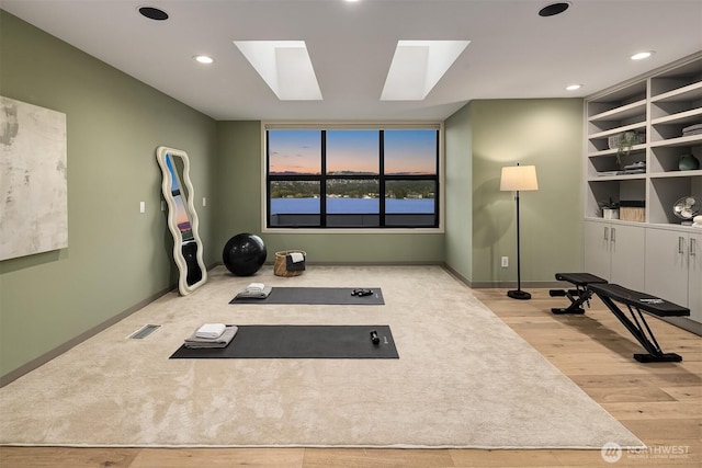 3840 E Mercer Way, Mercer Island, WA 98040 - exercise room featuring a skylight, wood finished floors, and recessed lighting