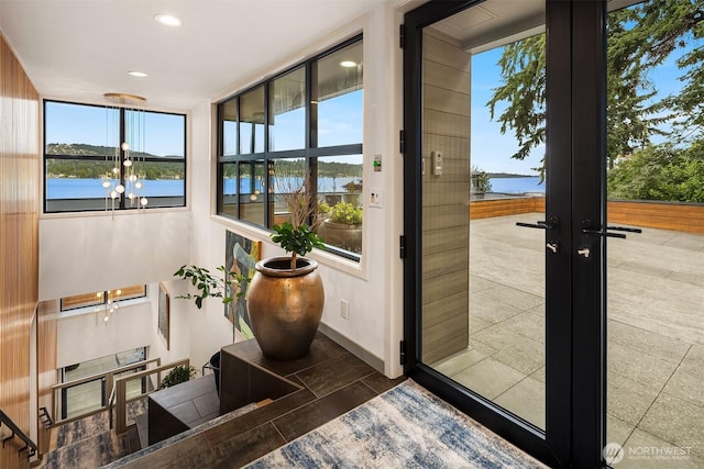 3840 E Mercer Way, Mercer Island, WA 98040 - sunroom / solarium featuring french doors, a water view, and healthy amount of natural light