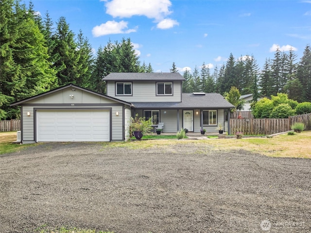 101 E Carols Pl, Belfair, WA 98528 - traditional-style house featuring a garage, covered porch, asphalt driveway, and a shingled roof