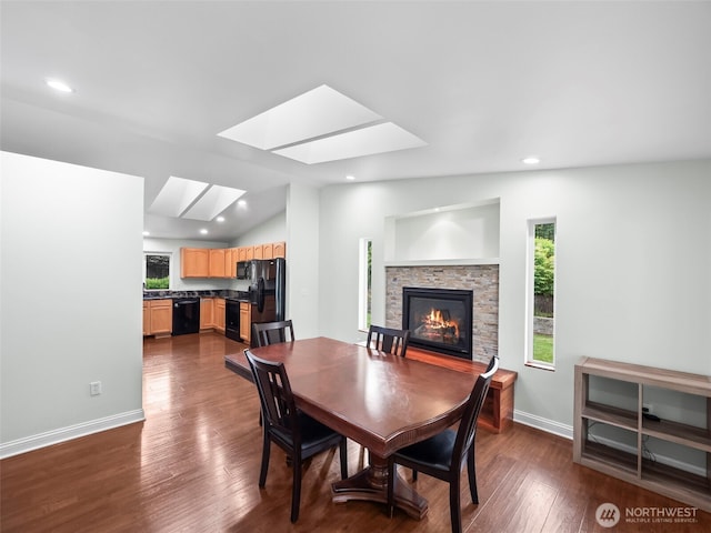 101 E Carols Pl, Belfair, WA 98528 - dining area with plenty of natural light, a skylight, a fireplace, dark wood-type flooring, and recessed lighting