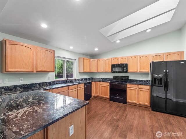 101 E Carols Pl, Belfair, WA 98528 - kitchen featuring black appliances, a skylight, vaulted ceiling, dark wood finished floors, and light brown cabinets