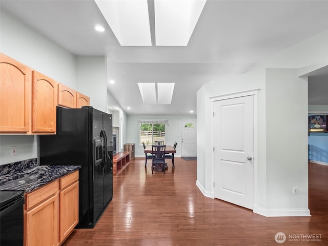 101 E Carols Pl, Belfair, WA 98528 - kitchen with a skylight, dark wood-type flooring, range with electric stovetop, black refrigerator with ice dispenser, and dark stone counters