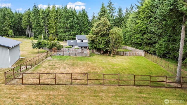 101 E Carols Pl, Belfair, WA 98528 - fenced backyard with an outdoor structure, a rural view, and a wooden deck