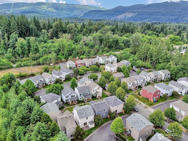9414 Hancock Ave SE, Snoqualmie, WA 98065 - aerial perspective of suburban area with a forest and mountains