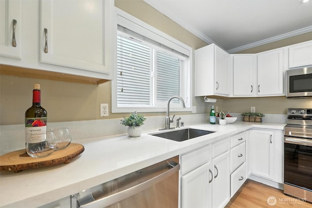 9414 Hancock Ave SE, Snoqualmie, WA 98065 - kitchen with stainless steel appliances, white cabinets, light countertops, crown molding, and light wood-style floors