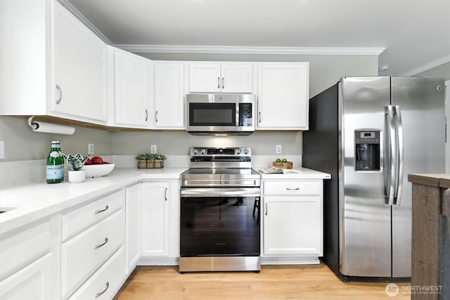 9414 Hancock Ave SE, Snoqualmie, WA 98065 - kitchen featuring appliances with stainless steel finishes, white cabinets, crown molding, and light countertops