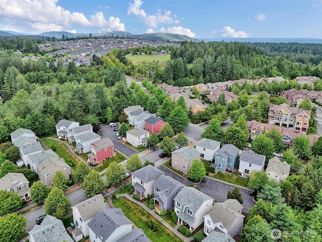 9414 Hancock Ave SE, Snoqualmie, WA 98065 - aerial perspective of suburban area with a heavily wooded area and mountains