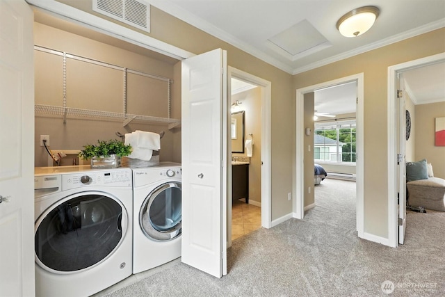 9414 Hancock Ave SE, Snoqualmie, WA 98065 - laundry area with washing machine and clothes dryer, light colored carpet, crown molding, attic access, and a baseboard radiator