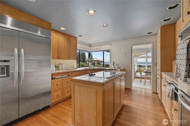 18035 8th Ave NW, Shoreline, WA 98177 - kitchen featuring stainless steel built in fridge, electric stovetop, a center island, wallpapered walls, and healthy amount of natural light