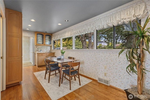 18035 8th Ave NW, Shoreline, WA 98177 - dining area with wallpapered walls, light wood-style floors, recessed lighting, and crown molding
