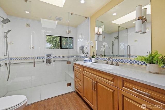 18035 8th Ave NW, Shoreline, WA 98177 - full bathroom with a skylight, vanity, a stall shower, wood finished floors, and recessed lighting