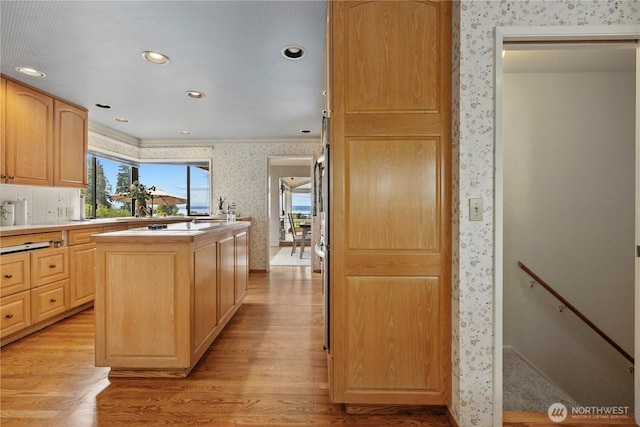 18035 8th Ave NW, Shoreline, WA 98177 - kitchen featuring wallpapered walls, light brown cabinetry, light wood-style flooring, a kitchen island, and light countertops