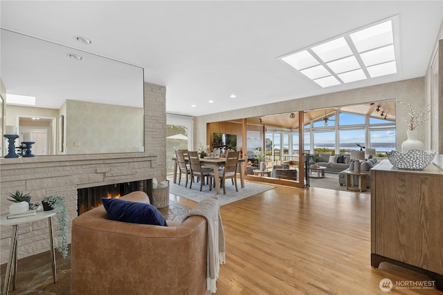 18035 8th Ave NW, Shoreline, WA 98177 - living area with wood finished floors, a stone fireplace, and recessed lighting