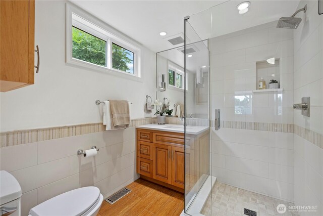 18035 8th Ave NW, Shoreline, WA 98177 - bathroom with a stall shower, vanity, tile walls, wood finished floors, and recessed lighting