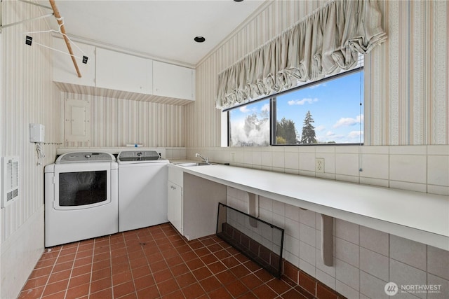 18035 8th Ave NW, Shoreline, WA 98177 - washroom featuring washer and dryer, dark tile patterned flooring, and wallpapered walls