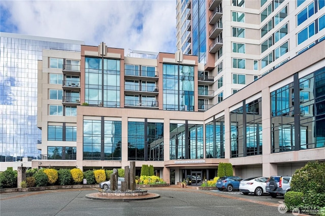 177 107th Ave NE Unit 1012, Bellevue, WA 98004 - view of apartment building / complex featuring uncovered parking