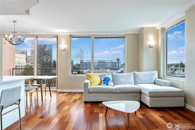 177 107th Ave NE Unit 1012, Bellevue, WA 98004 - living room featuring a chandelier, healthy amount of natural light, wood finished floors, and a view of city