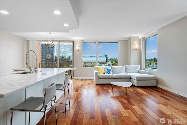 177 107th Ave NE Unit 1012, Bellevue, WA 98004 - living room featuring light wood-type flooring, a chandelier, and recessed lighting