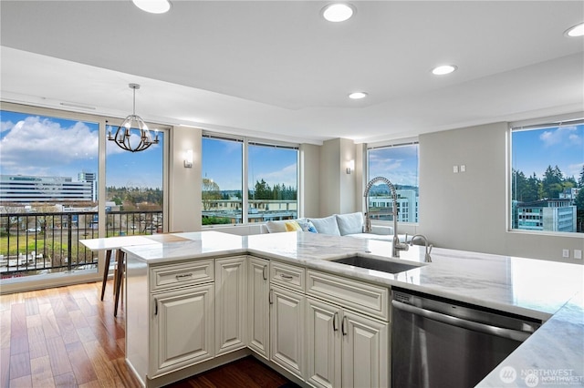 177 107th Ave NE Unit 1012, Bellevue, WA 98004 - kitchen with dishwasher, dark wood-style floors, light stone counters, recessed lighting, and hanging light fixtures