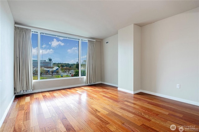 177 107th Ave NE Unit 1012, Bellevue, WA 98004 - spare room with wood finished floors and baseboards