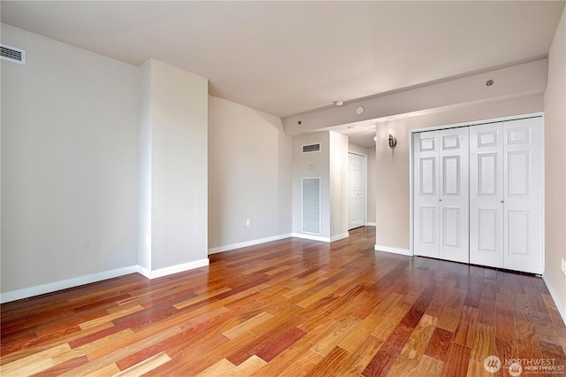 177 107th Ave NE Unit 1012, Bellevue, WA 98004 - unfurnished bedroom featuring wood finished floors and a closet