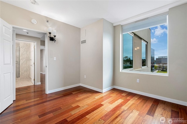 177 107th Ave NE Unit 1012, Bellevue, WA 98004 - empty room featuring light wood finished floors and a smoke detector