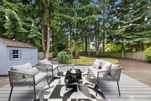 828 116th St SW, Everett, WA 98204 - wooden terrace featuring an outdoor hangout area, a fenced backyard, and a storage unit