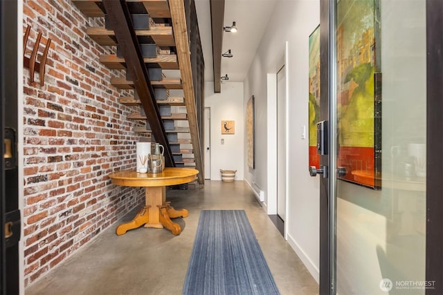 4566 Flying Goat Ave NE Unit C220, Bainbridge Island, WA 98110 - hall featuring finished concrete flooring, stairway, and brick wall