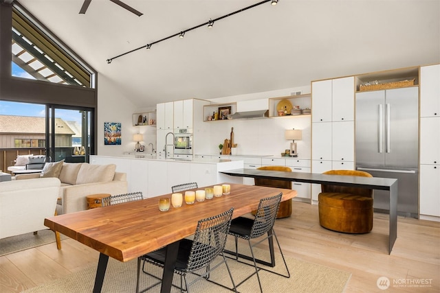 4566 Flying Goat Ave NE Unit C220, Bainbridge Island, WA 98110 - dining area featuring light wood-style flooring, a ceiling fan, high vaulted ceiling, and rail lighting