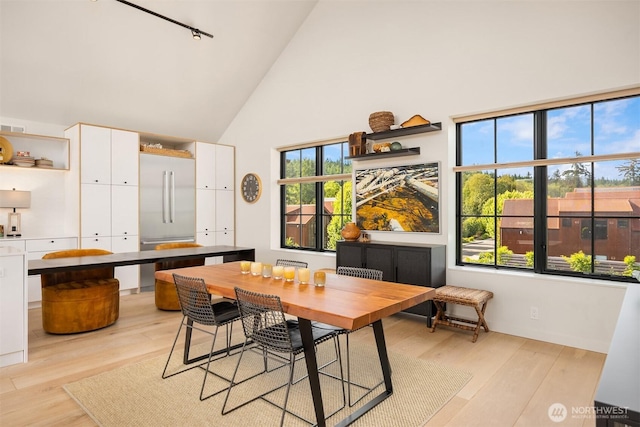 4566 Flying Goat Ave NE Unit C220, Bainbridge Island, WA 98110 - dining space with high vaulted ceiling and light wood-type flooring