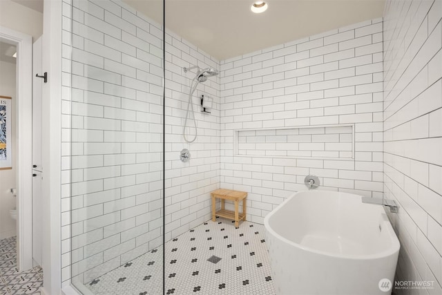 4566 Flying Goat Ave NE Unit C220, Bainbridge Island, WA 98110 - bathroom with a stall shower, tile walls, a freestanding tub, and tile patterned floors