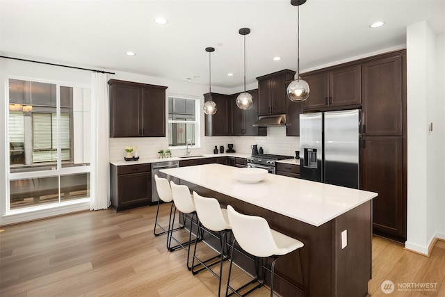 21822 25th Ave SE Unit B, Bothell, WA 98021 - kitchen with stainless steel appliances, plenty of natural light, dark brown cabinetry, tasteful backsplash, and recessed lighting