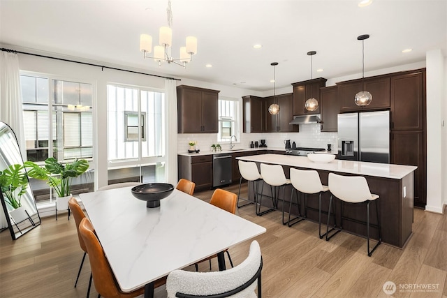 21822 25th Ave SE Unit B, Bothell, WA 98021 - kitchen featuring appliances with stainless steel finishes, dark brown cabinets, backsplash, a center island, and recessed lighting