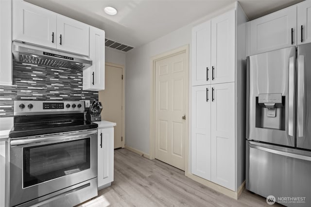 16907 Lookout Mountain Rd SE, Monroe, WA 98272 - kitchen with appliances with stainless steel finishes, ventilation hood, light wood finished floors, and white cabinetry