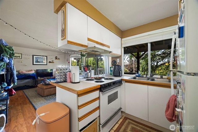 606 N State St, Bellingham, WA 98225 - kitchen with white appliances, white cabinets, open floor plan, and light countertops