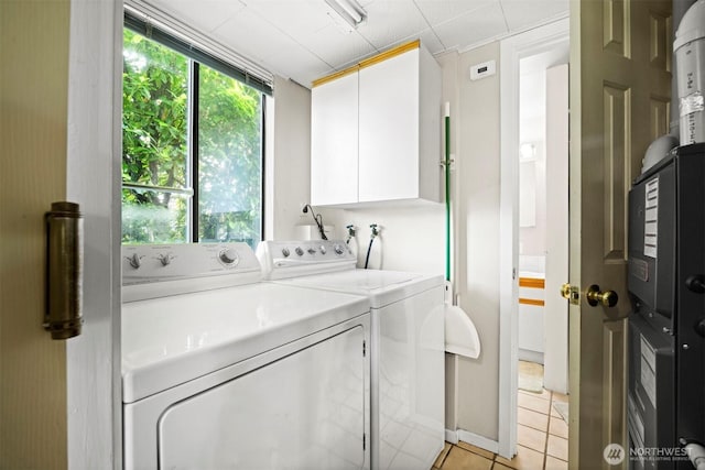 606 N State St, Bellingham, WA 98225 - laundry room with independent washer and dryer, light tile patterned flooring, and cabinet space