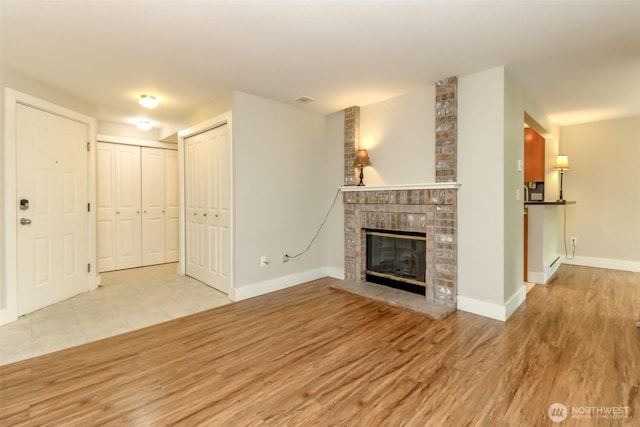 3008 N Narrows Dr Unit B102, Tacoma, WA 98407 - unfurnished living room with wood finished floors and a fireplace