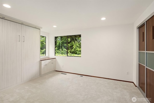5665 E Mercer Way, Mercer Island, WA 98040 - unfurnished bedroom featuring light colored carpet and recessed lighting