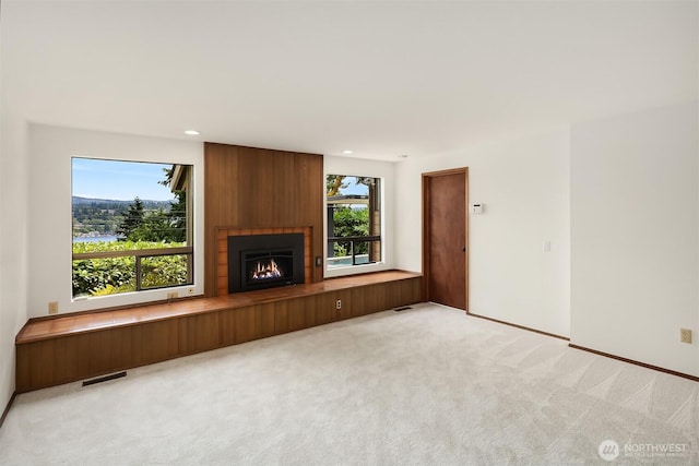 5665 E Mercer Way, Mercer Island, WA 98040 - unfurnished living room with light colored carpet, a fireplace, and recessed lighting