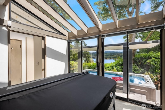 5665 E Mercer Way, Mercer Island, WA 98040 - sunroom featuring a water view, a jacuzzi, a skylight, and vaulted ceiling