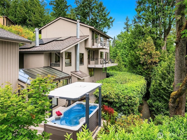 5665 E Mercer Way, Mercer Island, WA 98040 - view of property exterior featuring a hot tub, a shingled roof, a balcony, and outdoor dining space