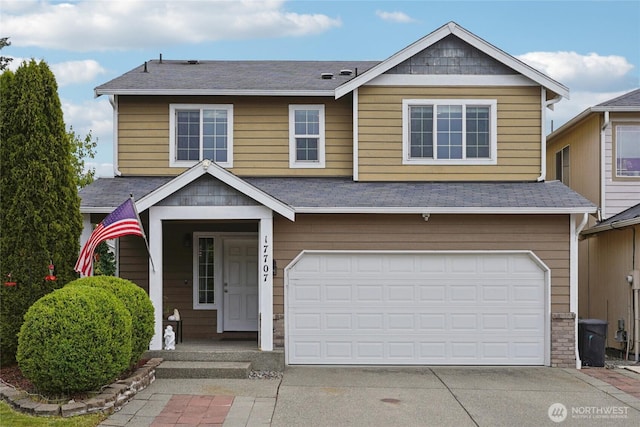 17707 1st Avenue Ct E, Spanaway, WA 98387 - view of front of house with concrete driveway, a garage, and roof with shingles