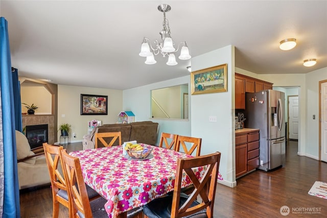17707 1st Avenue Ct E, Spanaway, WA 98387 - dining room featuring a chandelier, dark wood-style floors, and a fireplace